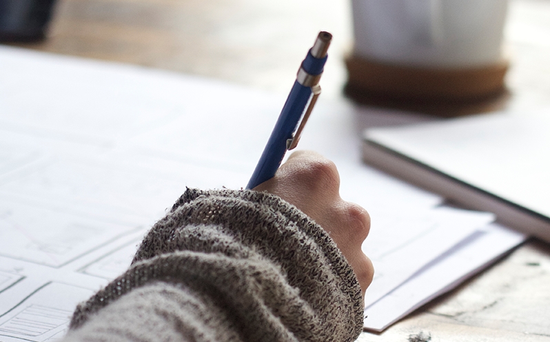 A man's hand with pencil in his hand